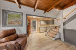 This stunning property boasts a spacious open-plan living area with hardwood floors and a cozy leather recliner.