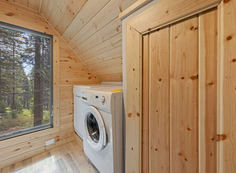 Cozy cabin with a laundry room featuring a washer and dryer.