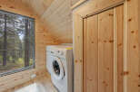 Cozy cabin with a laundry room featuring a washer and dryer.