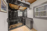 This stunning bathroom boasts a walk-in shower with pebble flooring and sleek black marble tile.