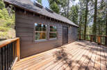 This charming cabin boasts a spacious deck perfect for enjoying the surrounding forest views.