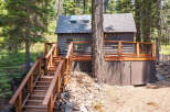 This charming cabin nestled in the woods offers a peaceful retreat.