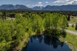 Mountain views and a serene pond enhance this picturesque property.
