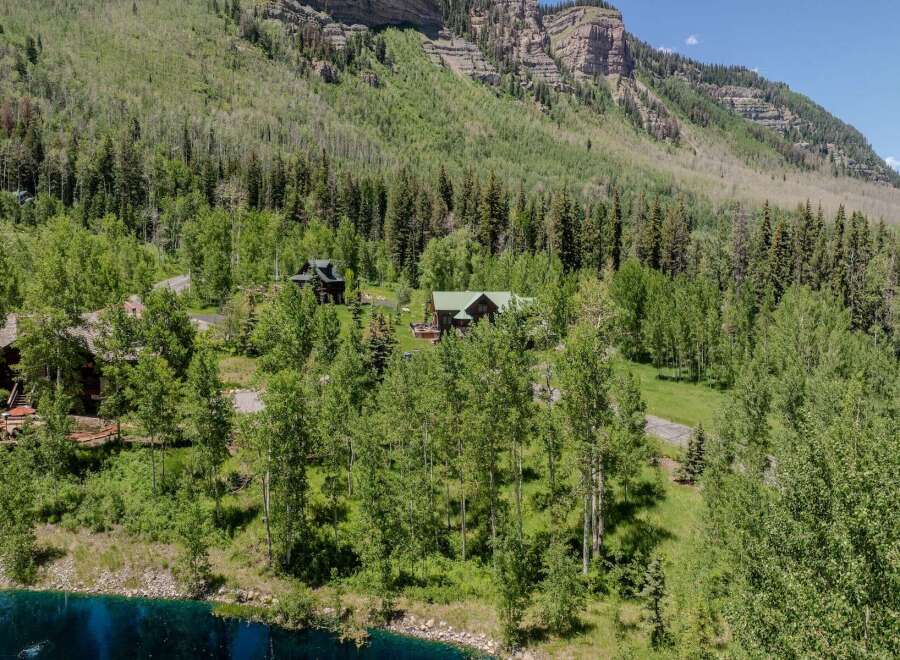 Mountaintop retreat nestled in lush greenery with stunning views.