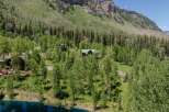 Mountaintop retreat nestled in lush greenery with stunning views.