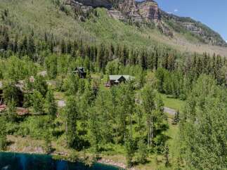 Mountaintop retreat nestled in lush greenery with stunning views.