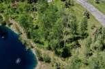 This stunning property boasts a serene, private setting with a picturesque pond and mature aspen trees.