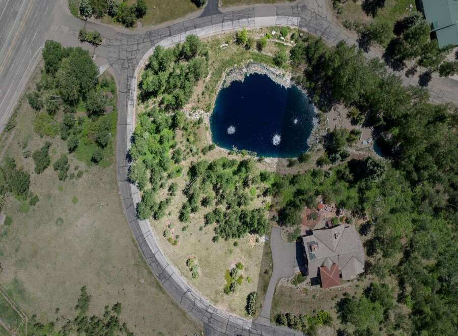 Nestled in a serene mountain setting, this exceptional property boasts a private pond and lush landscaping.