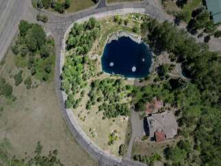 Nestled in a serene mountain setting, this exceptional property boasts a private pond and lush landscaping.