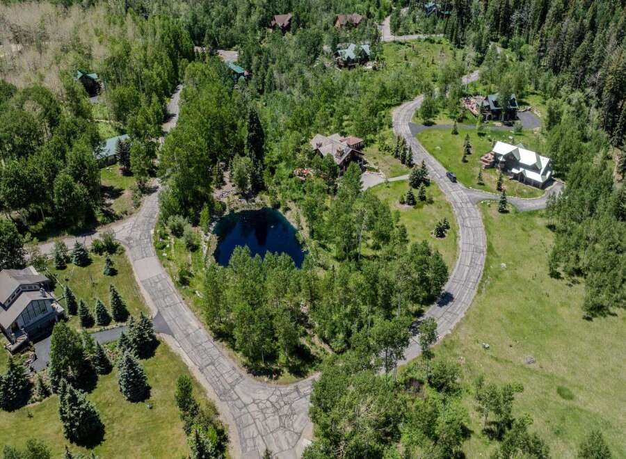 This secluded mountain property boasts stunning views and a private pond.