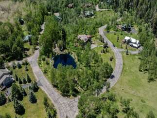 This secluded mountain property boasts stunning views and a private pond.