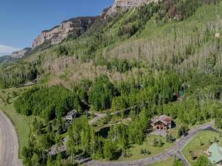 Nestled in a mountainside forest, this stunning property offers breathtaking views and a tranquil atmosphere.