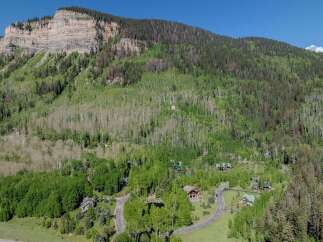 Nestled in a mountainside forest, this secluded property offers breathtaking views and a tranquil atmosphere.