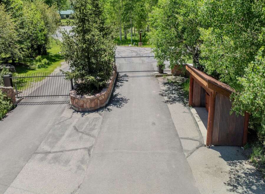 This secluded property boasts a private gated entrance, ensuring privacy and security.