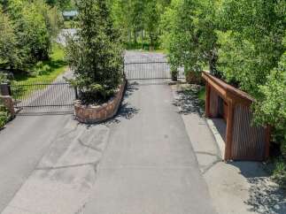 This secluded property boasts a private gated entrance, ensuring privacy and security.