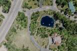 This stunning property boasts a private pond, surrounded by lush greenery and mature trees.