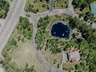This stunning property boasts a private pond, surrounded by lush greenery and mature trees.