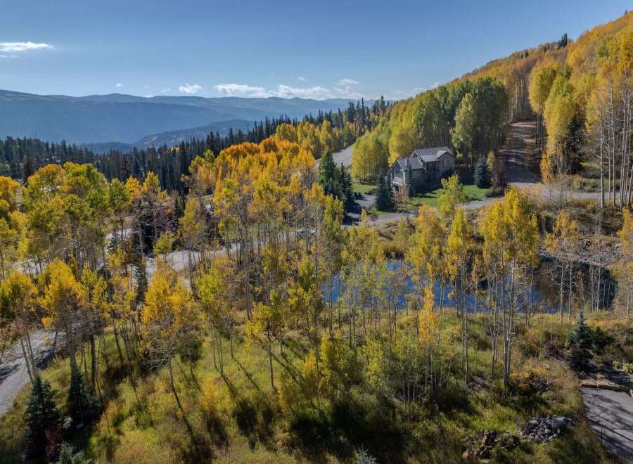 Nestled amidst the vibrant hues of autumn, this stunning property offers a serene escape.