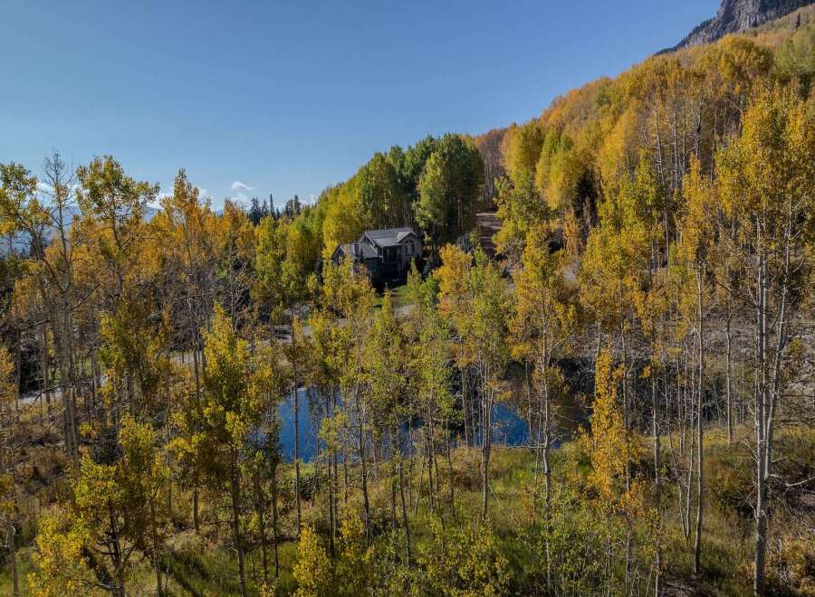 Nestled amidst the vibrant hues of autumn foliage, this stunning property offers a serene escape.
