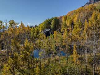 Nestled amidst the vibrant hues of autumn foliage, this stunning property offers a serene escape.