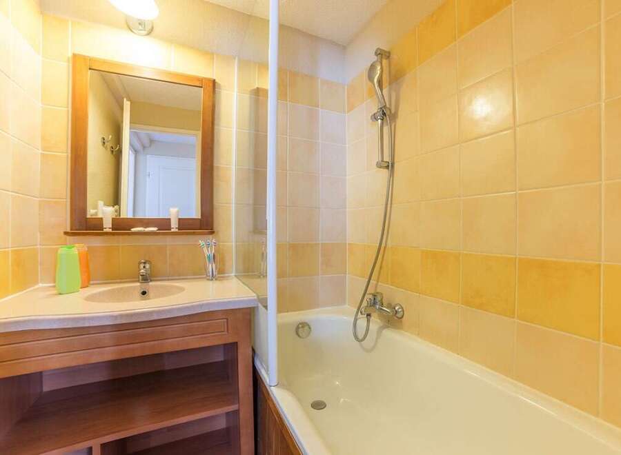 This charming bathroom boasts a bathtub and shower combination, perfect for relaxing after a long day.
