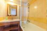 This charming bathroom boasts a bathtub and shower combination, perfect for relaxing after a long day.