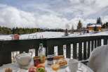 Enjoy a delightful breakfast on your private balcony overlooking breathtaking snowy mountain views.