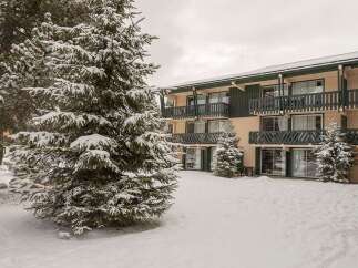 Nestled in a snowy landscape, this charming hotel offers comfortable accommodations with stunning views.