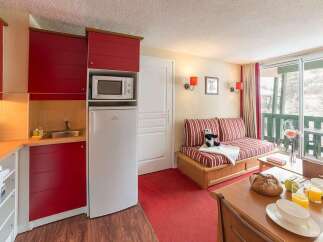 This cozy studio apartment features a fully equipped kitchenette with microwave and refrigerator, perfect for a comfortable stay.
