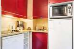 This charming kitchen boasts modern appliances including a dishwasher, microwave, and refrigerator, perfect for a comfortable stay.