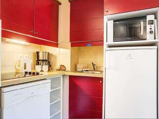 This charming kitchen boasts modern appliances including a dishwasher, microwave, and refrigerator, perfect for a comfortable stay.