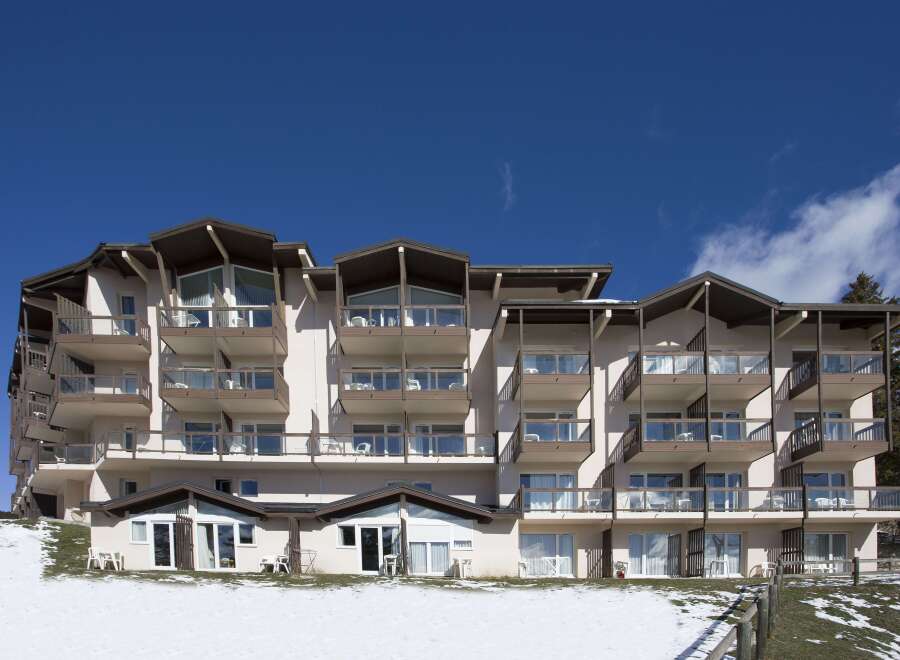 This stunning ski resort hotel boasts multiple floors with private balconies, offering breathtaking views.
