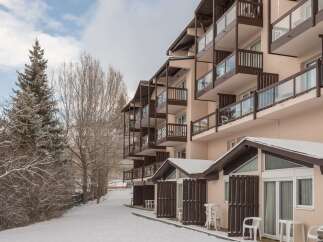 This stunning ski resort property boasts multiple floors of spacious rooms, each with its own private balcony offering breathtaking views.