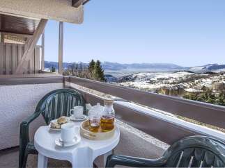 Enjoy breathtaking mountain views from your private balcony, perfect for a relaxing morning tea.