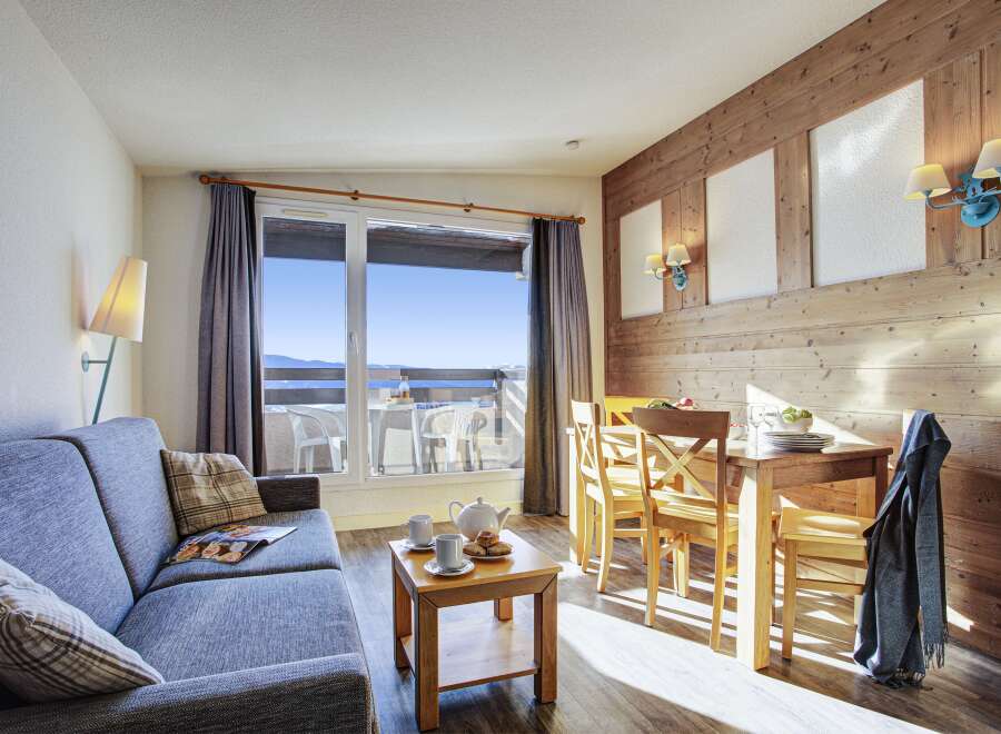 This stunning apartment boasts breathtaking mountain views from its large window and private balcony.