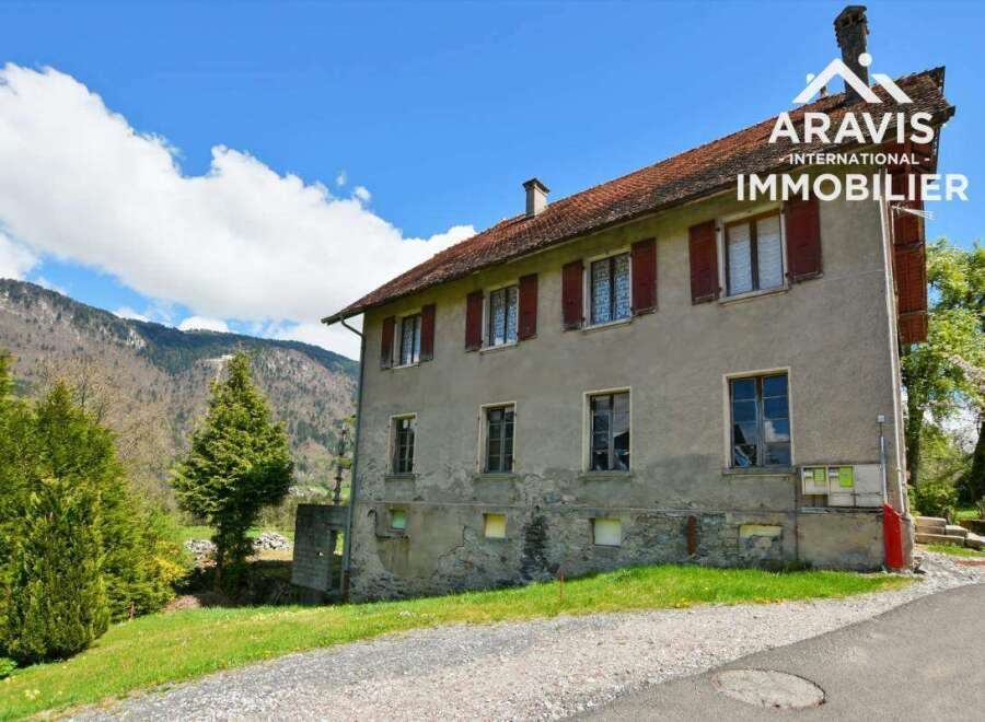This charming farmhouse boasts stunning mountain views and offers ample space with multiple bedrooms and windows.