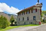 This charming farmhouse boasts stunning mountain views and offers ample space with multiple bedrooms and windows.