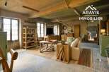 Rustic-chic living space with exposed beams and large windows.