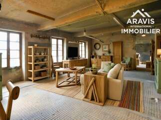 Rustic-chic living space with exposed beams and large windows.