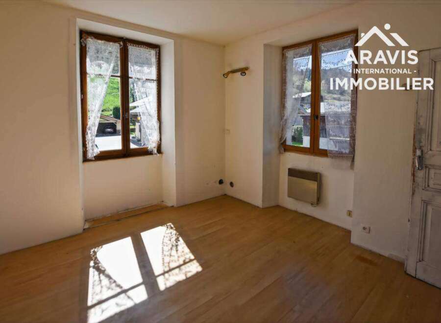 Bright and spacious room with hardwood floors and large windows offering plenty of natural light.