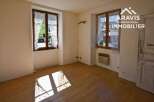Bright and spacious room with hardwood floors and large windows offering plenty of natural light.