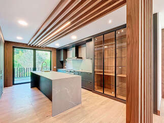 Step into luxury with this stunning kitchen! Featuring a sleek island, modern cabinetry, and elegant glass-fronted display cabinets, this space is designed for both style and functionality.