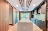 This stunning kitchen boasts a modern design with sleek cabinetry and a spacious island, perfect for culinary enthusiasts.