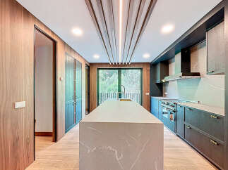 This stunning kitchen boasts a modern design with sleek cabinetry and a spacious island, perfect for culinary enthusiasts.