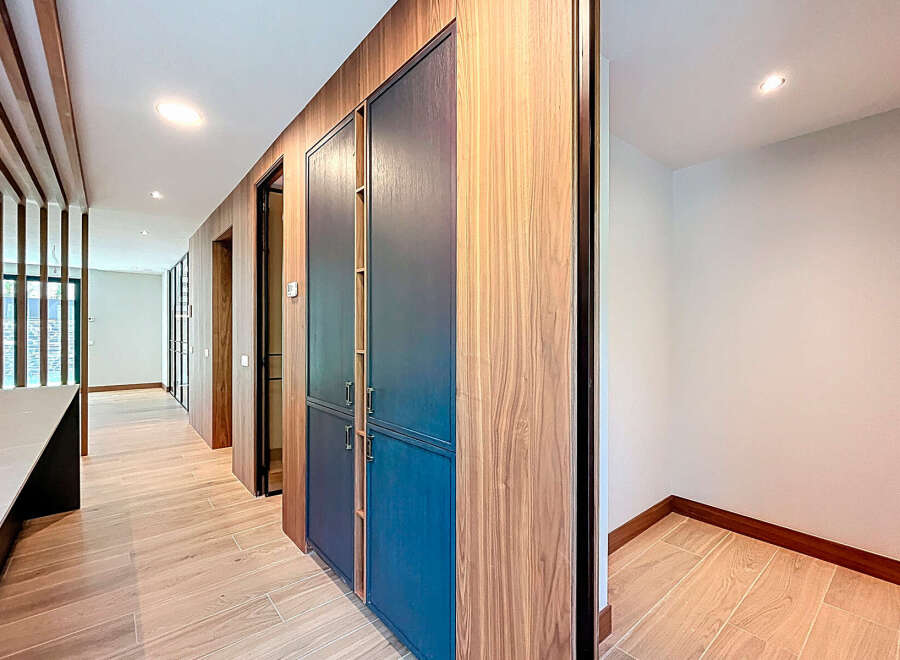 Explore the elegant design of this property, featuring stunning wooden accents and a modern aesthetic.