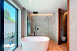 Indulge in luxury within this stunning bathroom, featuring a sleek, modern design.