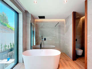 Indulge in luxury within this stunning bathroom, featuring a sleek, modern design.