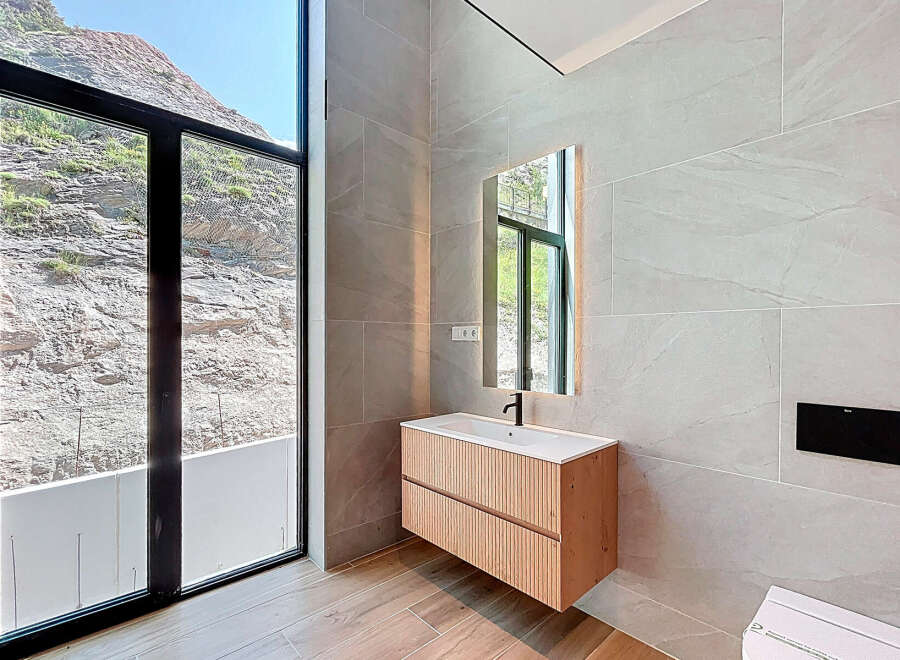 Experience luxury in this stunning bathroom with breathtaking mountain views.