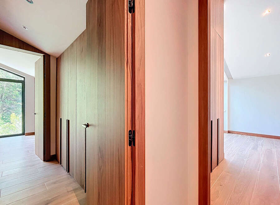 Discover the elegance of this modern property, featuring stunning wooden accents and a seamless design.