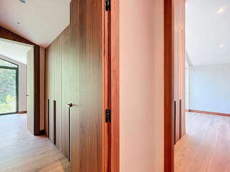 Discover the elegance of this modern property, featuring stunning wooden accents and a seamless design.